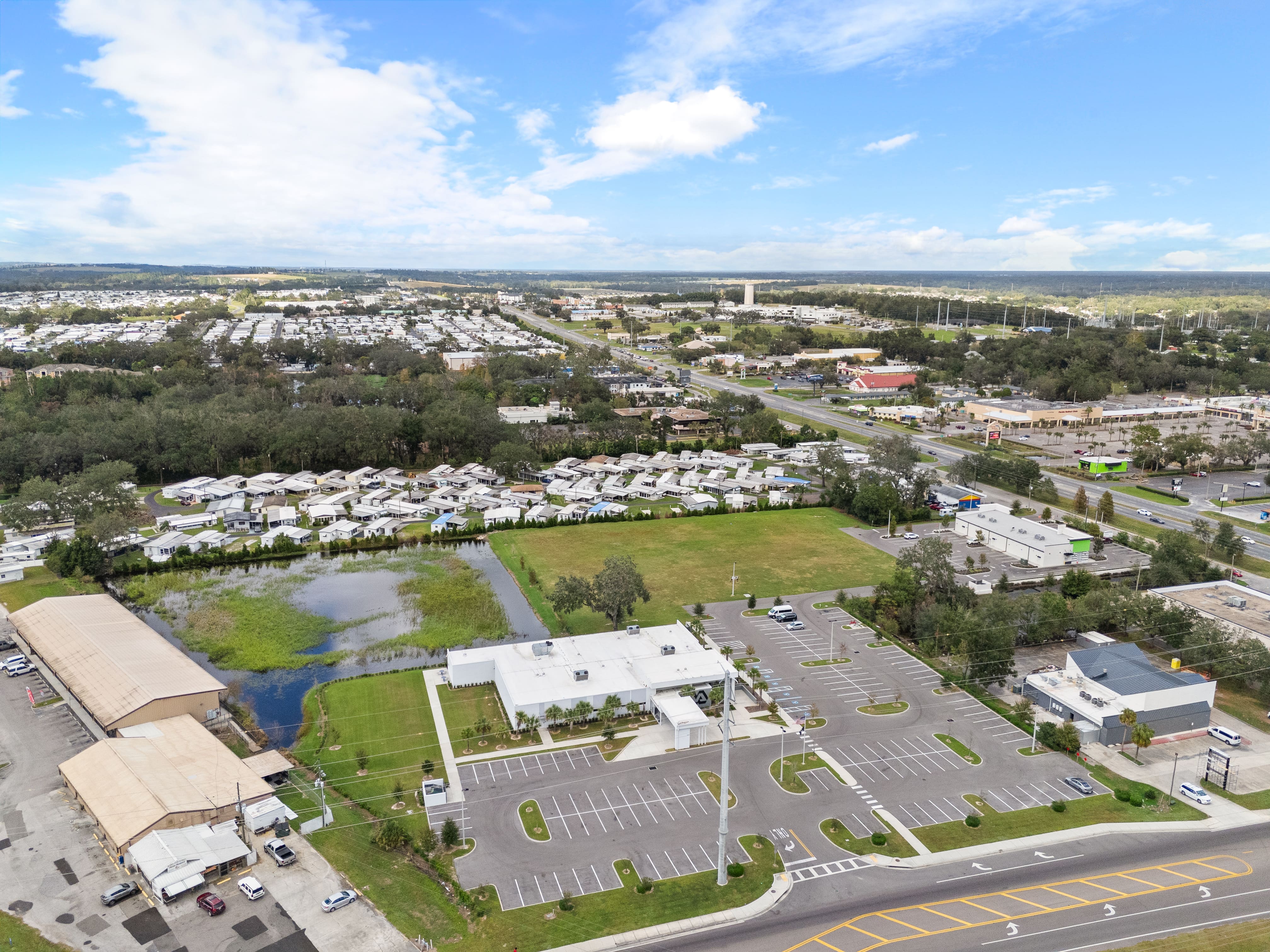 High-angle aerial view of Zephyrhills VA Clinic showing the full property, adjacent roads, and RV park nearby
