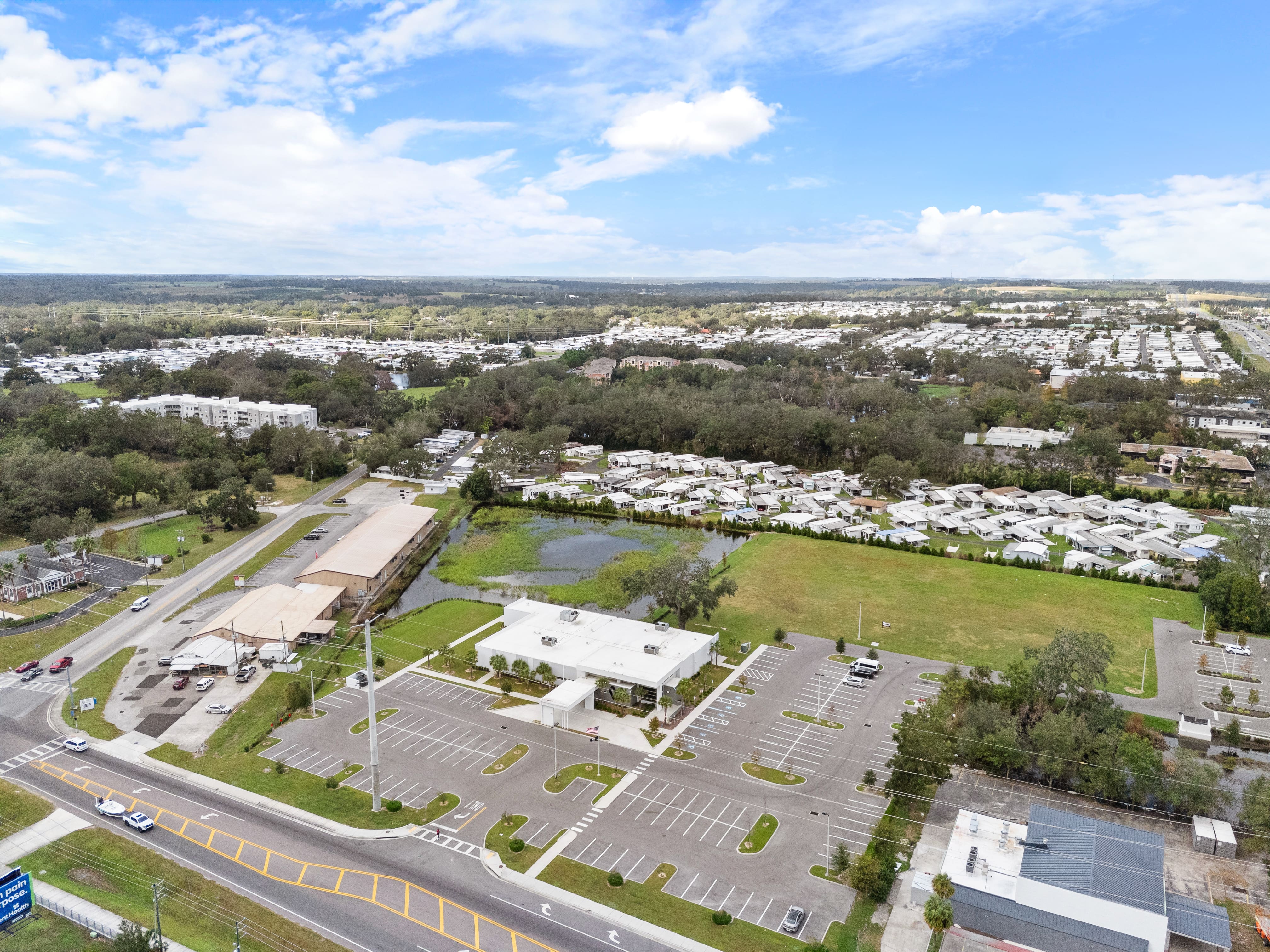 Aerial photo of Zephyrhills VA Clinic showing site layout, adjacent water retention area, and RV neighborhood