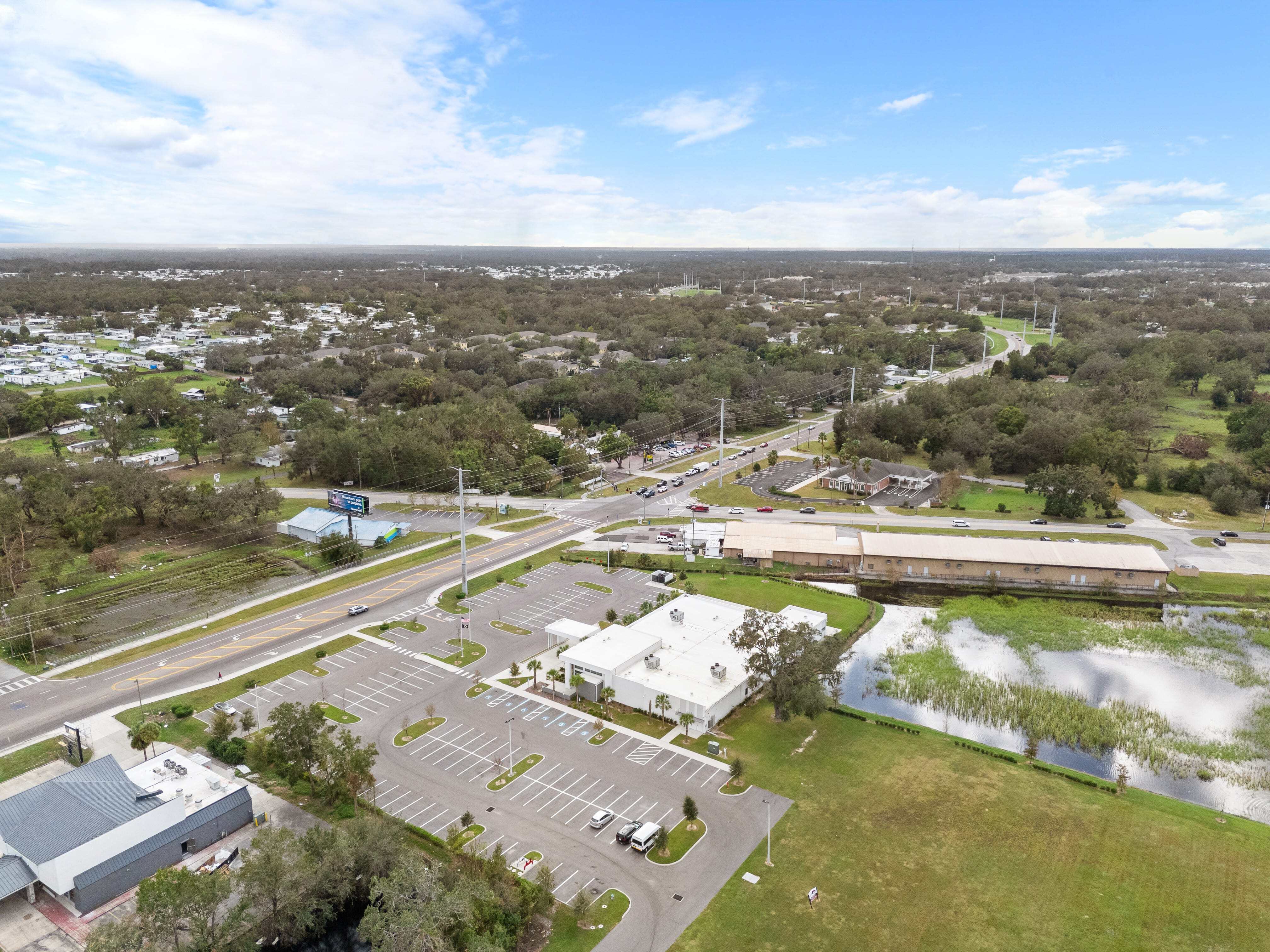 Oblique aerial of Zephyrhills VA Clinic from above Dale Mabry showing roads, lots, and stormwater pond