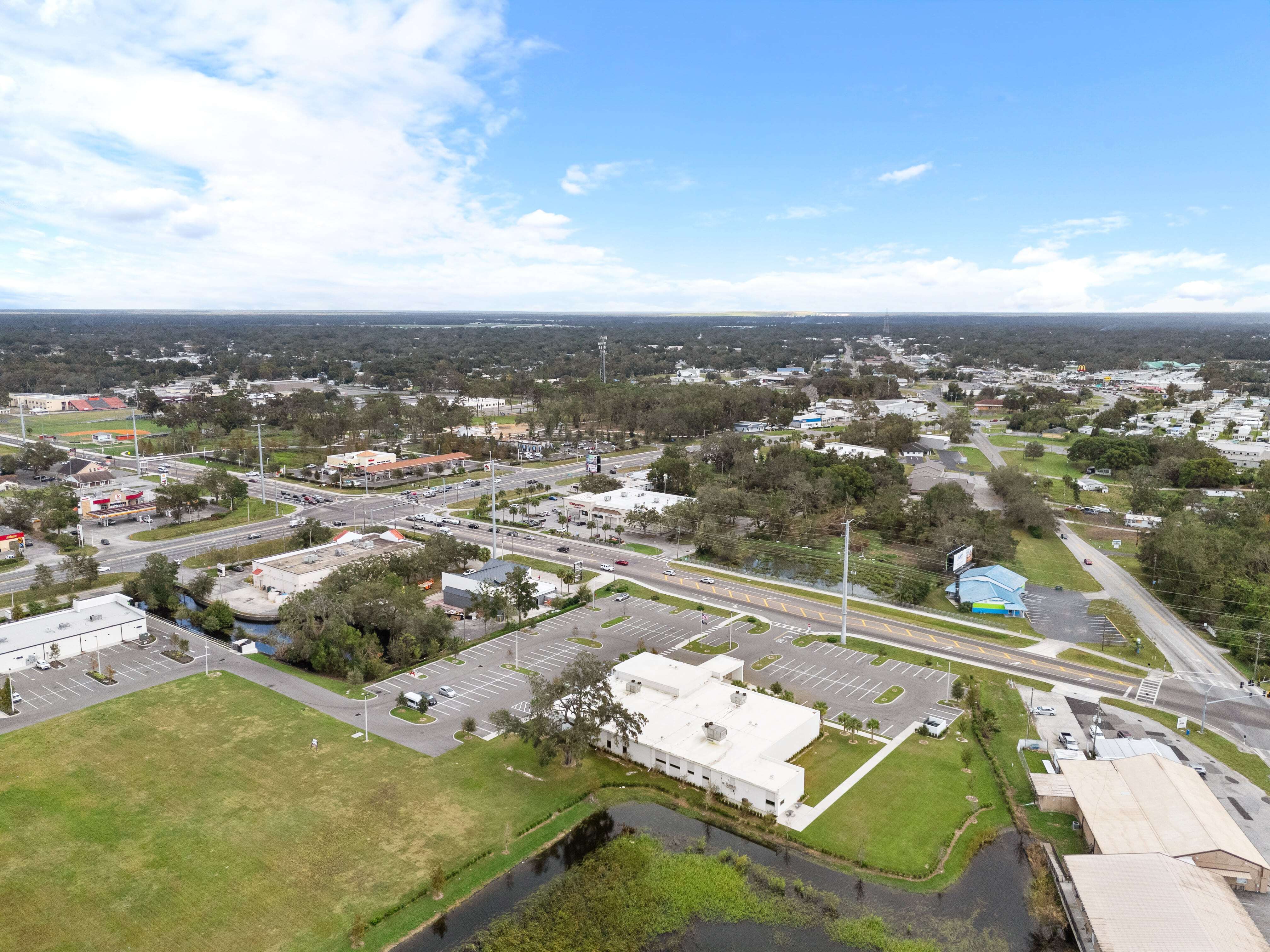 Overhead view of VA Clinic Zephyrhills property, parking layout, and surrounding suburban area