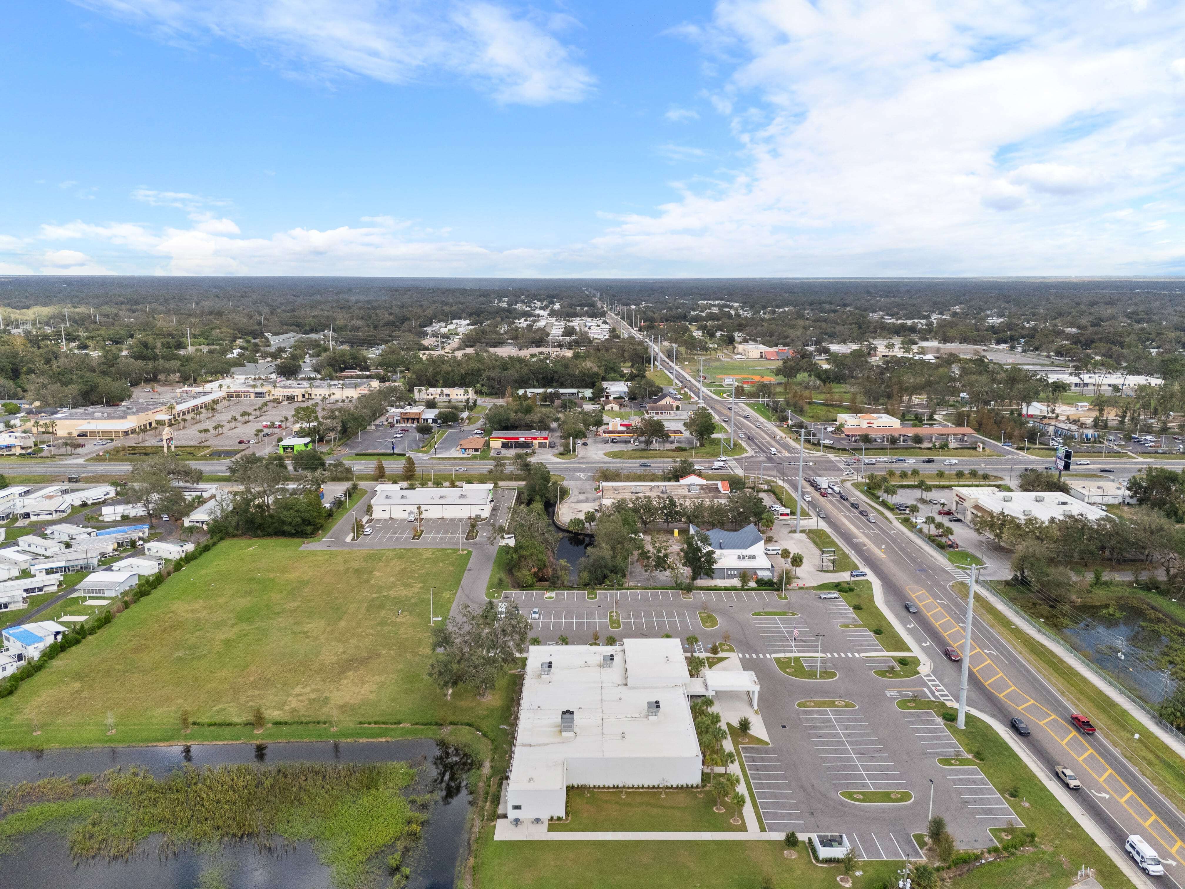 High-altitude aerial image of VA Clinic in Zephyrhills, Florida with visible street traffic and site access