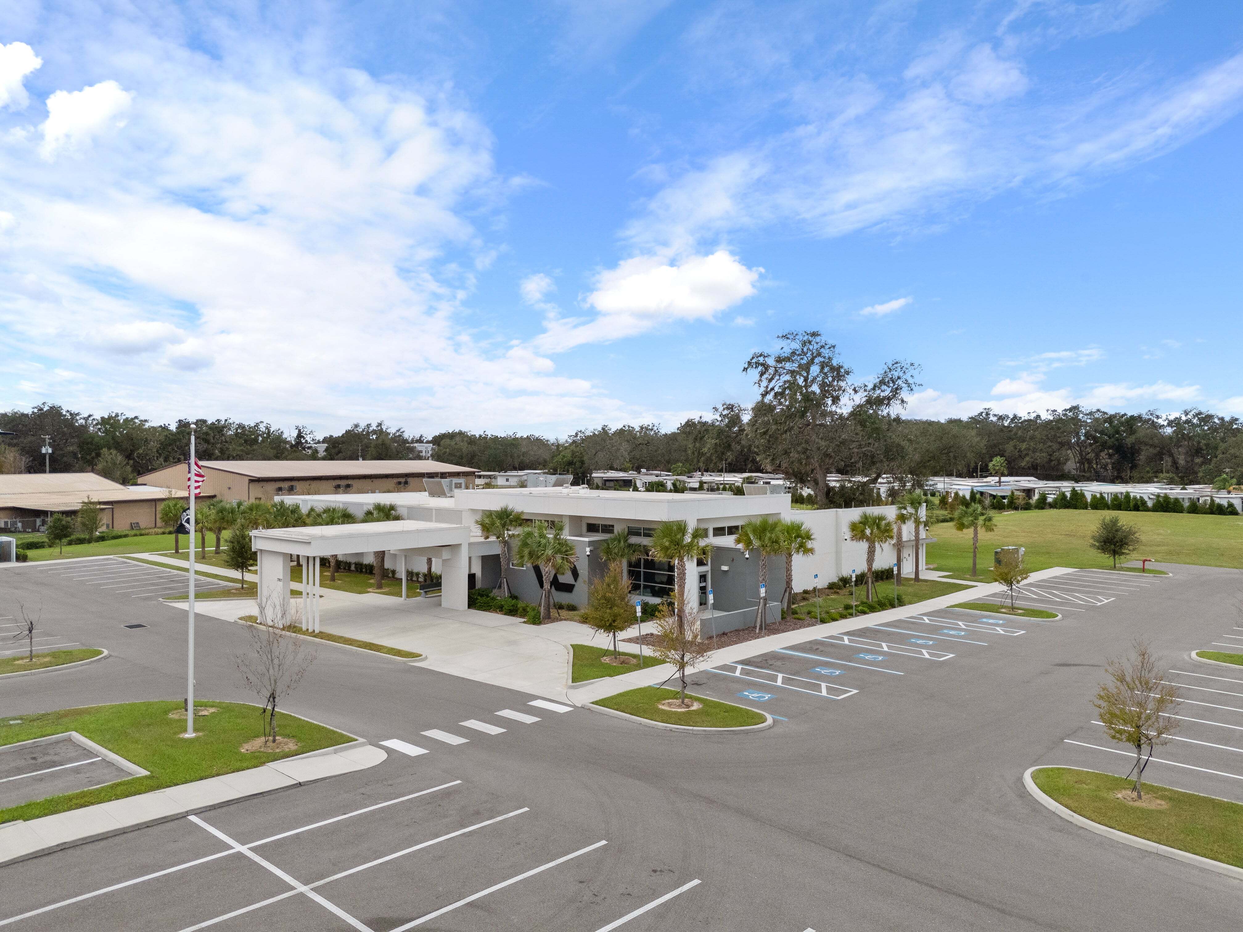 ADA-compliant parking spaces with view of clinic canopy and landscaped front entrance