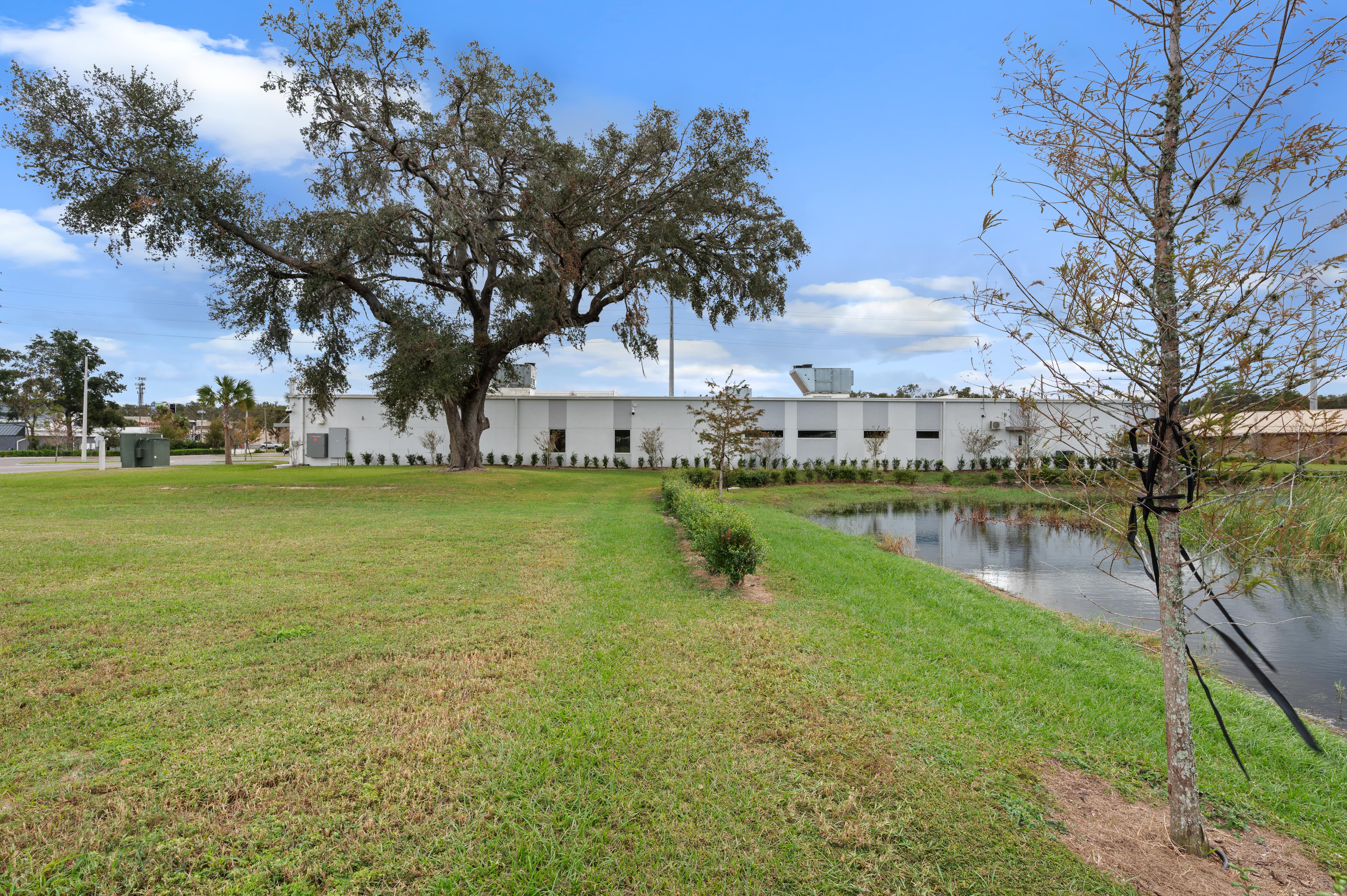 Another angle of the rear exterior showing utility infrastructure and a secondary access area behind the clinic.