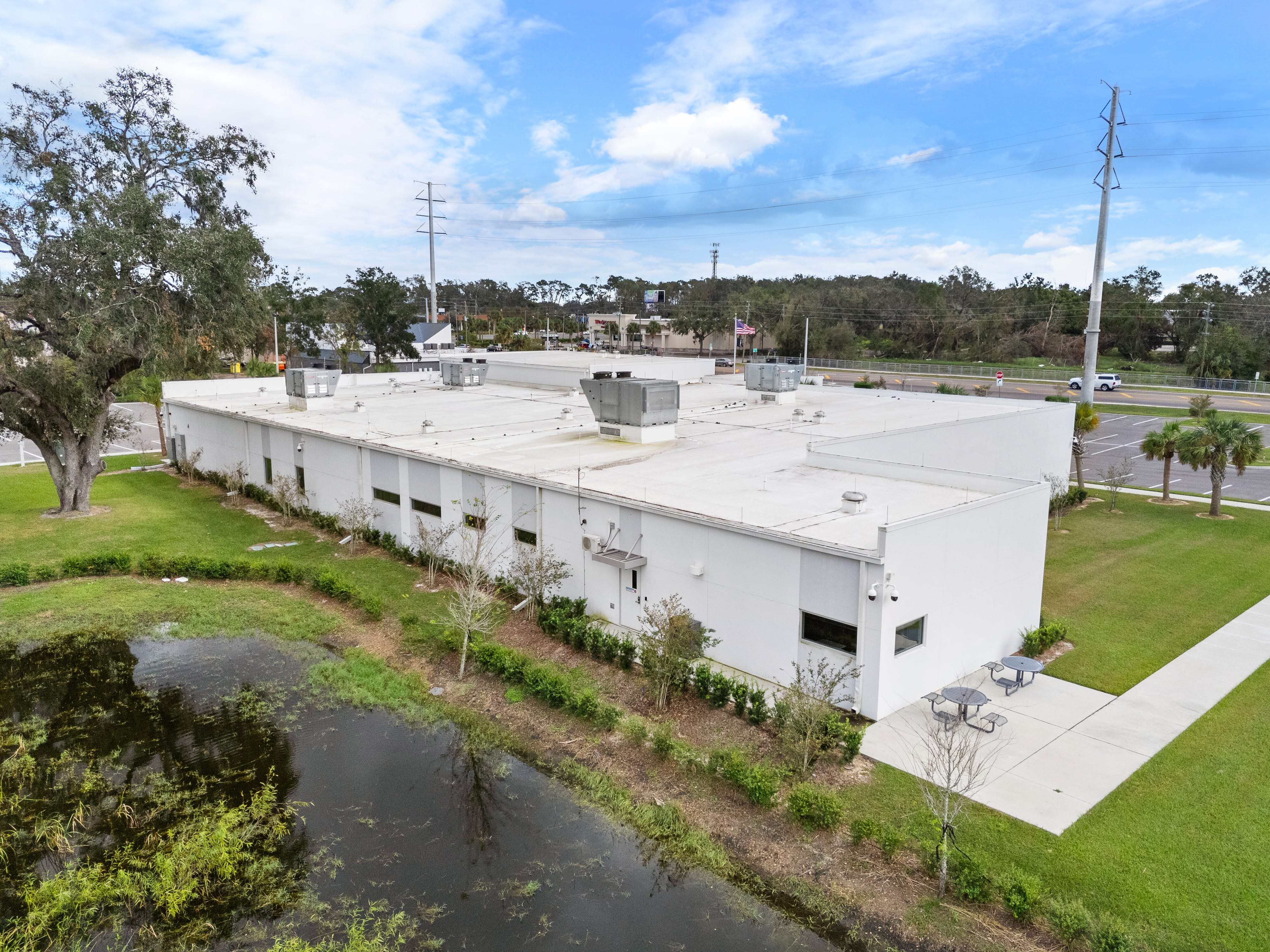 Side view of the VA clinic with clean architectural lines, stucco finish, and an adjacent walkway.